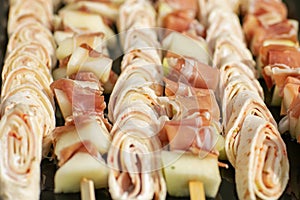 Pork skewers with bacon on white background