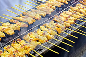 Pork skewers grilled on a stove, Pork satay is one of street food on Bangkok, Thailand