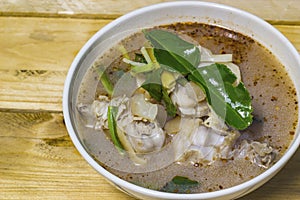 Pork in spicy soup with herbs