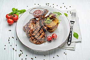 Pork steak with bone and potato pancakes