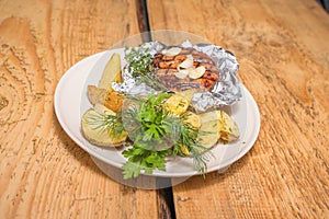 Pork steak in foil with potatoes