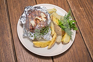 Pork steak in foil with potatoes