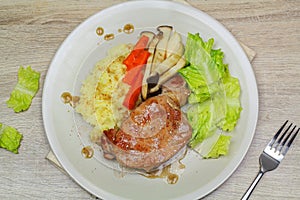 Pork steak with mashed potatoes and mushroom