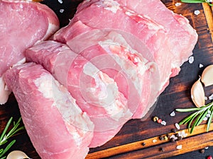 Pork steak, raw carbonate fillet on dark background, meat with r
