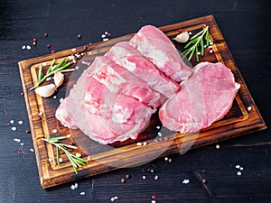 Pork steak, raw carbonate fillet on dark background, meat with r