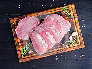 Pork steak, raw carbonate fillet on dark background, meat with r