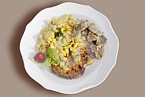 Pork tenderlion with SpÃÂ¤tzle and champignons served on plate photo