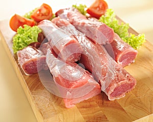 Pork tenderloin. Arrangement on a cutting board. photo