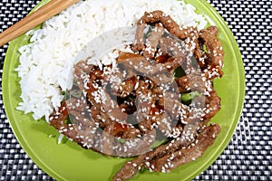 Pork in teriyaki sauce with slices of cucumber with cucumber slices and bread photo