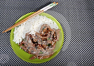 Pork in teriyaki sauce with slices of cucumber with cucumber slices and bread photo