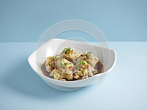 Pork Wanton in Chilli Vinaigrette with chopsticks served in a dish isolated on mat side view on grey background