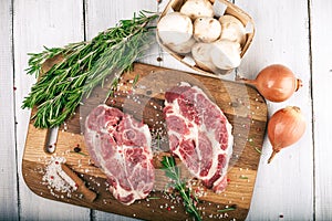 Porky steak with spice and herb on wood background