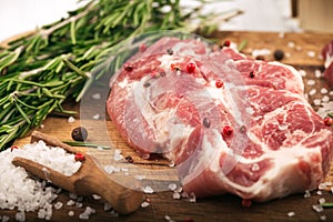 Porky steak with spice and herb on wood background