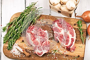 Porky steak with spice and herb on wood background