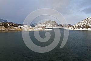 Porma Reservoir with Snow Mountains photo