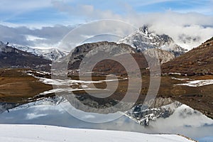 Porma reservoir, Susaron peak snowy and its reflection in the water. Lion. Spain photo