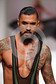 star extraordinaire Boomer Banks walks the runway at the Marco Marco fashion show during SS 2016