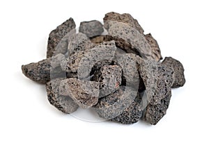 Porous black volcanic rock. Lava stone, pumice stone, or volcanic pumice with distinctive pores