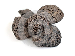 Porous black volcanic rock. Lava stone, pumice stone, or volcanic pumice with distinctive pores