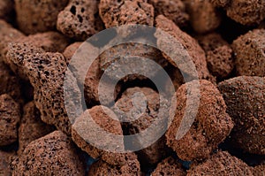 Porous brown volcanic rock. Lava stone, pumice stone, or volcanic pumice with distinctive pores