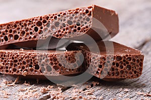 Porous chocolate and crumb on an old wooden table