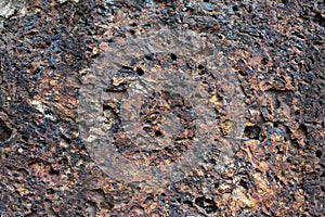 Porous volcanic rock wall, old stone background