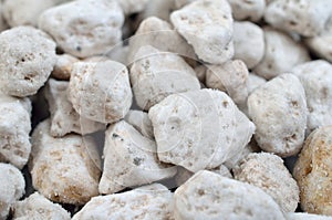 Porous white volcanic rock. Lava stone, pumice stone, or volcanic pumice with distinctive pores