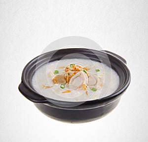 Porridge or abalone porridge in claypot on a background.