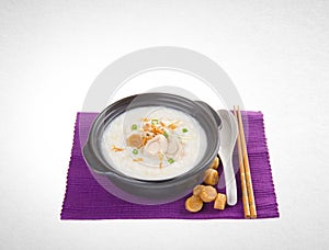 Porridge or abalone porridge in claypot on a background.