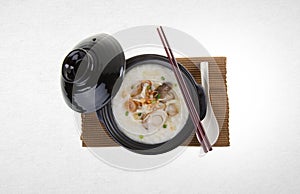 Porridge or abalone porridge in claypot on a background.