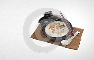 Porridge or abalone porridge in claypot on a background.