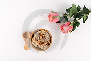 Composition Porridge, Cinnamon, Almonds in a wooden bowl and wooden spoon. ans Two Pink Roses isolated on white background, photo