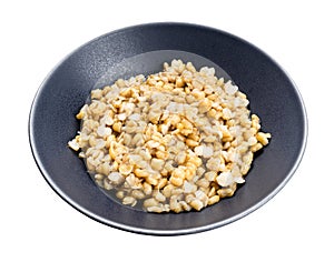 Porridge from kamut khorasan wheat in gray bowl