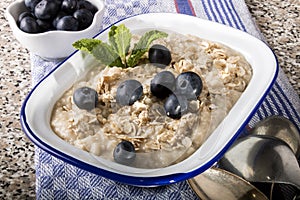 Porridge made with traditional irish oatmeal in an enamel bowl