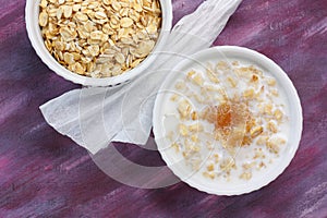 Porridge with milk and brown sugar and raw rolled oats