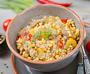 Porridge from Turkish couscous with beef and vegetables.