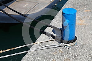 Port bitt bollard with tied mooring ropes