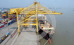 Port cargo crane and container terminal for loading bulk cargo of iron ore by ship cranes and grabs.Container Cargo freight ship