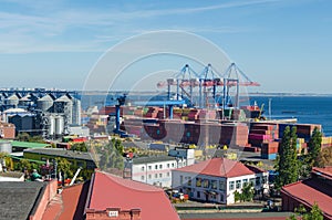 Port cargo crane loads a container onto a cargo ship