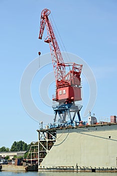The port crane on ship dock in port. City Svetlyj, Kaliningrad region