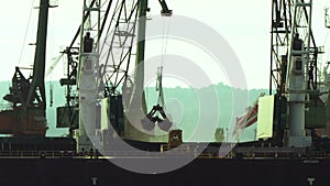 Port crane unloading and loading grain