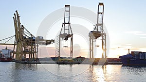 Port cranes in barcelona, on a sunny winter evening