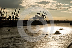 Port cranes at sunset