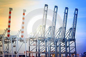 Port cranes working in sea port, Crane of freight dock, Working crane bridge in shipyard at twilight