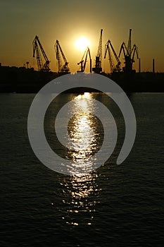 port derricks silhouette in a sunset