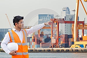 Port engineer standing in front of the industrial harbor