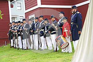 Union soldiers and drummer boy standing for review