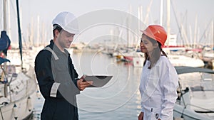 Port inspector and female seafarer shaking hands