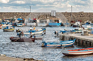 The port of Isola delle Femmine or Island of Women with fishing boats and fishermen at work, province of Palermo, Sicily, Italy