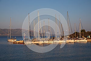 Port of Kastos island with moored yachts, sailboats - Ionian sea, Greece in summer evening.